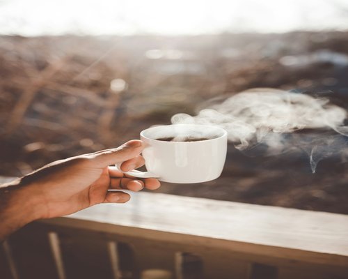 Hands holding a warm cup of coffee